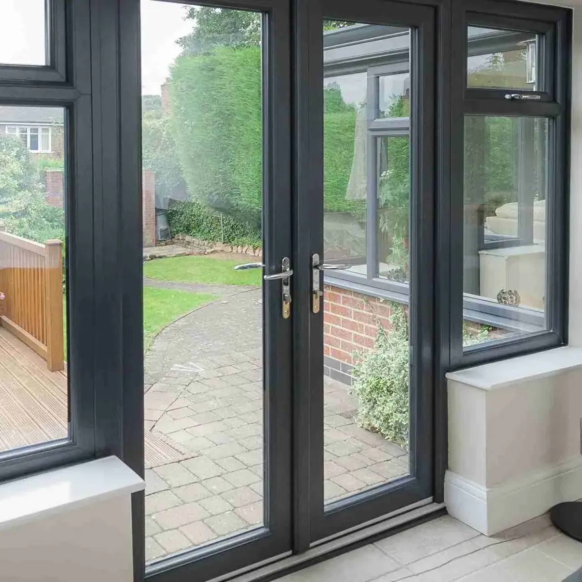Dark French doors opening onto a garden