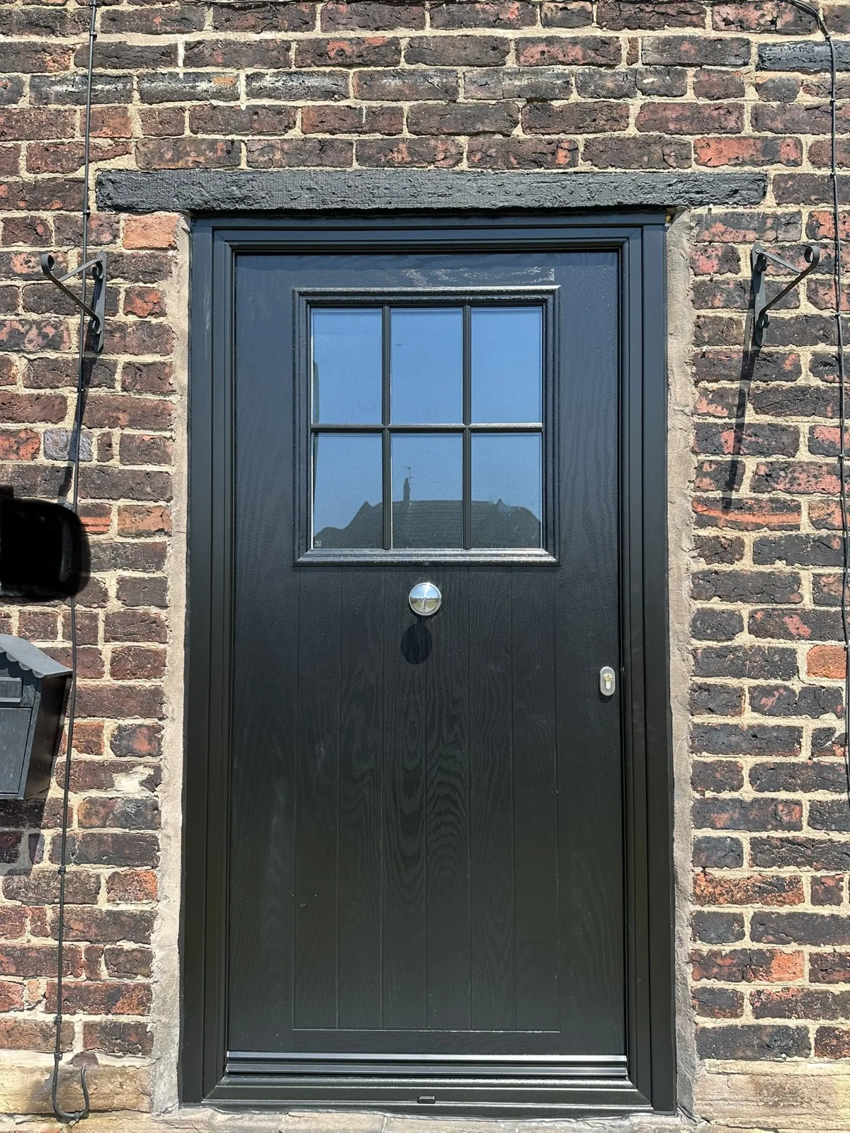 Black composite door with small-paned glazing